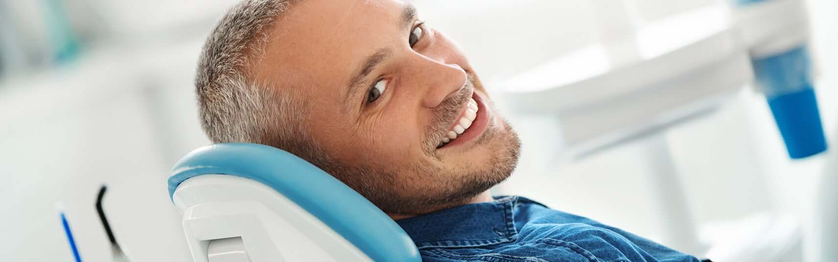 smiling man sitting in a dental chair