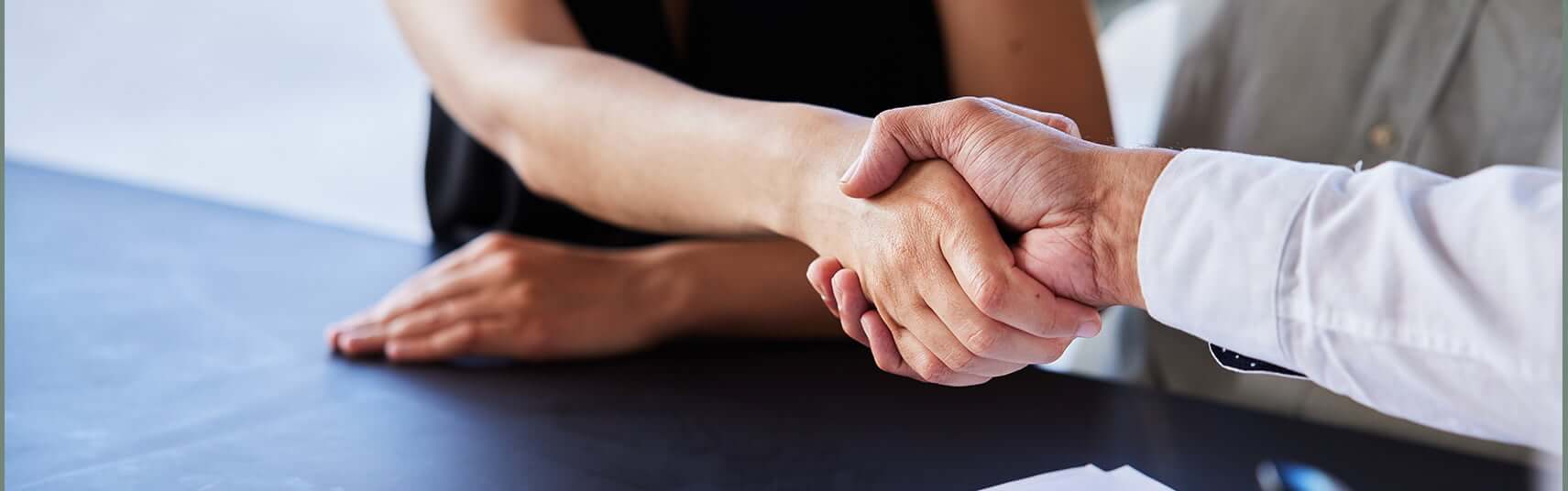 dentist and patient shaking hands