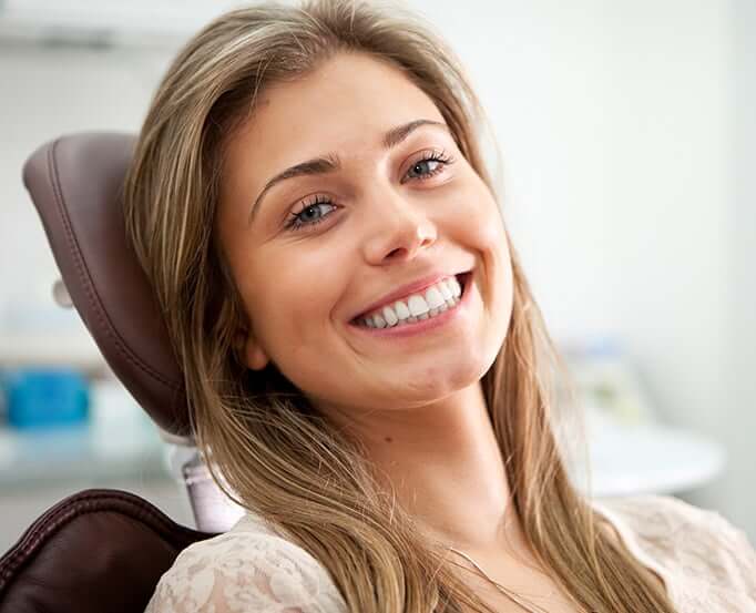 smiling woman sitting in a dental chair