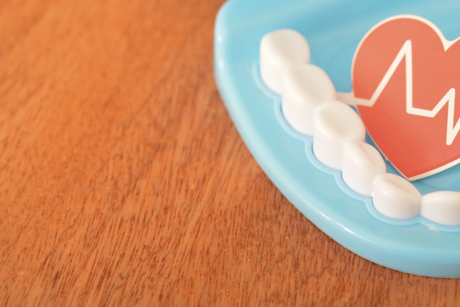 gum disease and heart health, oral health is connected to overall health motif