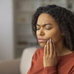 woman with cavitation pain after tooth extraction who needs cavitation surgery