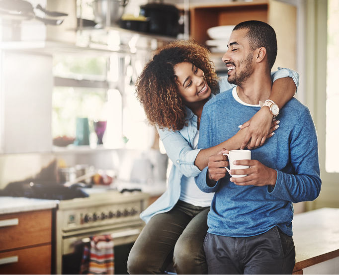 Man and woman hugging in their kitchen