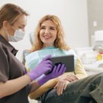 Dentist showing patient exam results on a tablet.