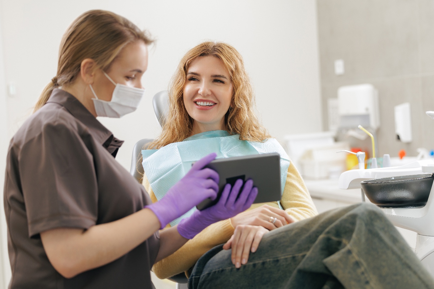 Dentist showing patient exam results on a tablet.