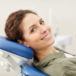 A woman smiling in a dental chair