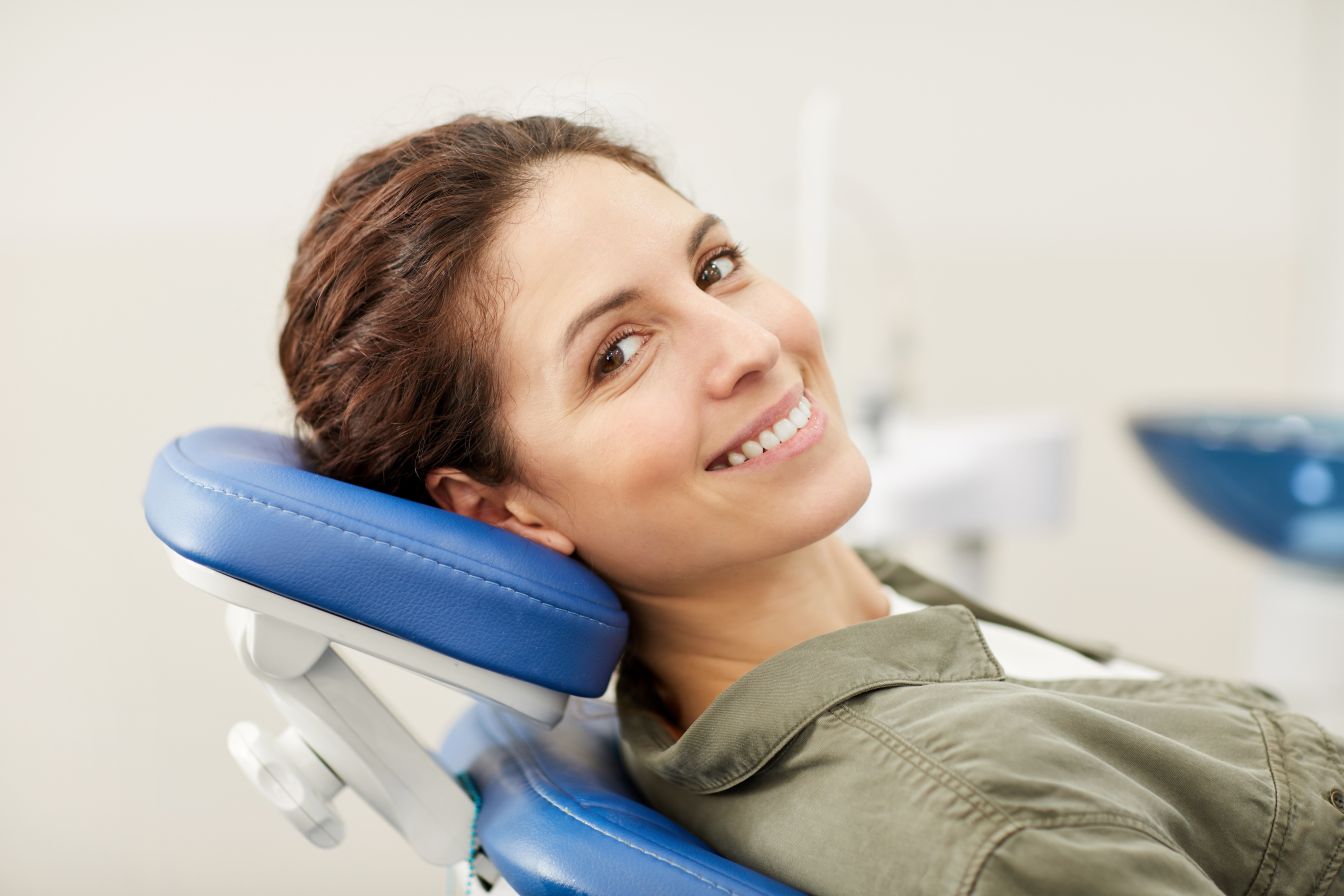 A woman smiling in a dental chair
